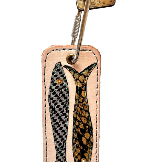 Leather keychain with fish design on a white background