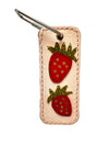 Keychain with strawberry designs on a beige background