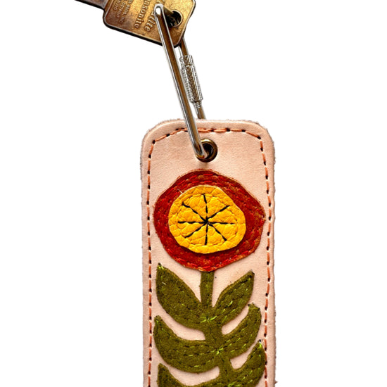 Keychain with floral design on a white background